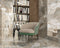 Stol foran høj bogreol med Ravello Naturale marmor fliser på vægge og gulv